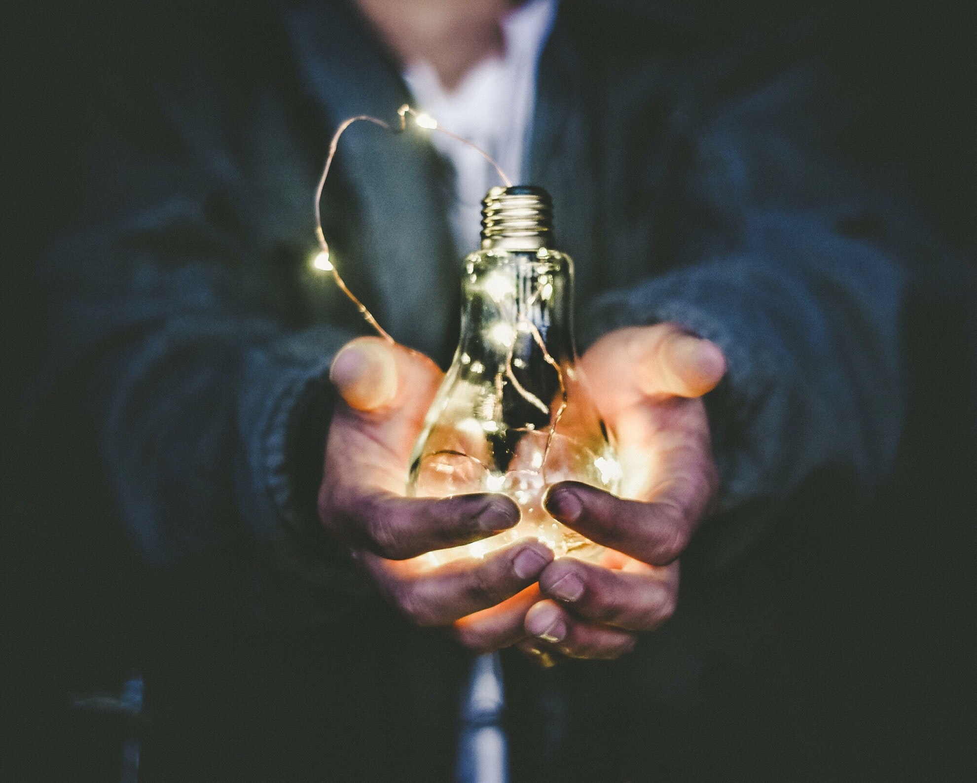 man holding light bulb